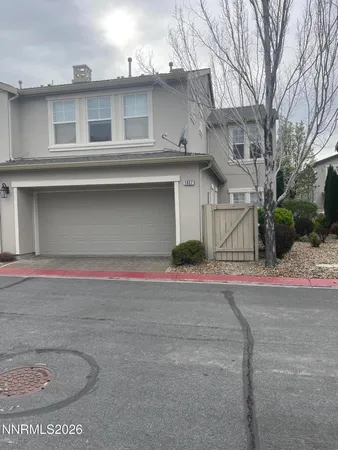 a front view of a house with a road