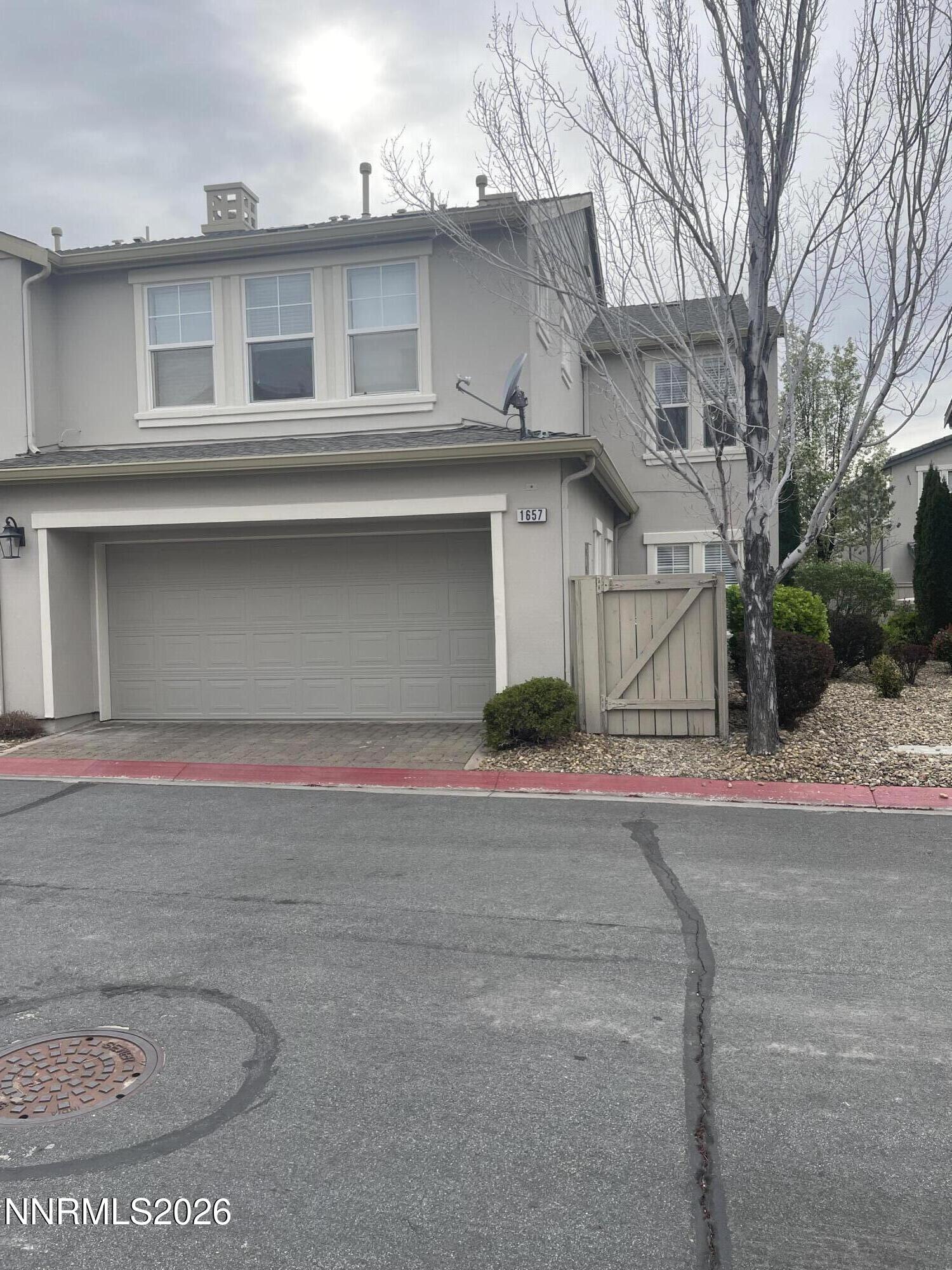 a front view of a house with a road