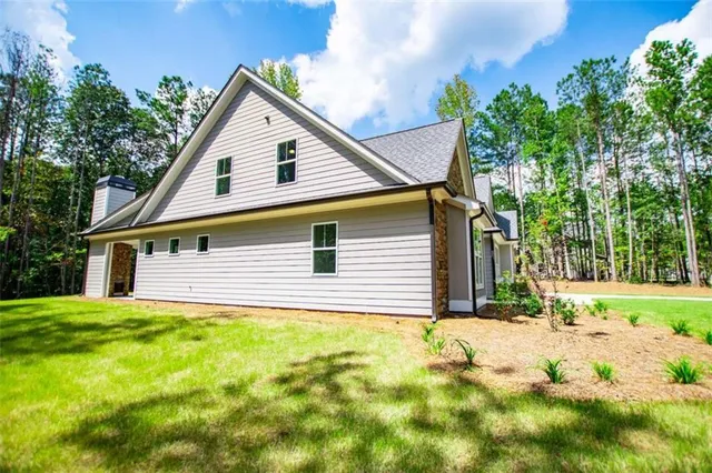 a large kitchen with kitchen island a stove a sink dishwasher and a refrigerator with wooden floor