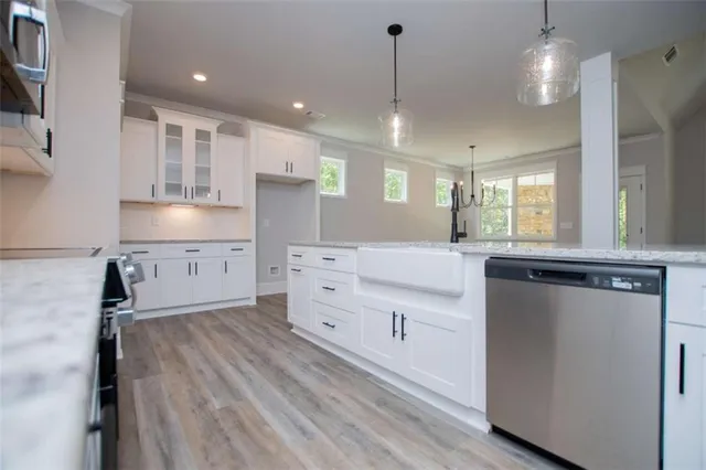 a bathroom with a granite countertop sink a toilet a mirror and shower