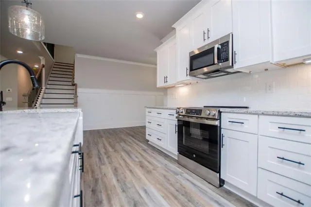 a view of a hallway with wooden floor and entryway