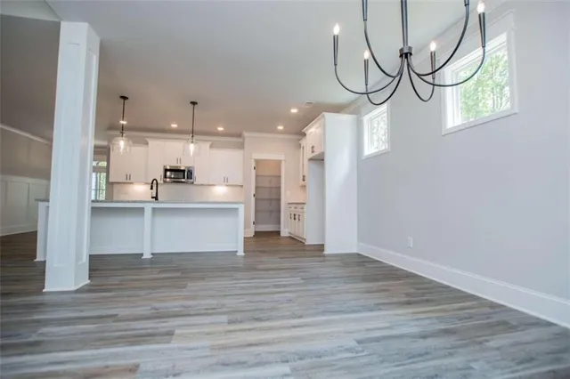 a spacious bathroom with a double vanity sink mirror and bathtub