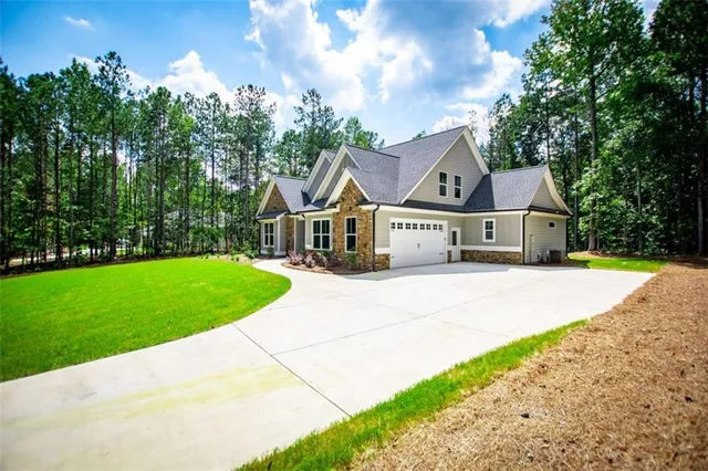 a front view of the house with yard porch and green space