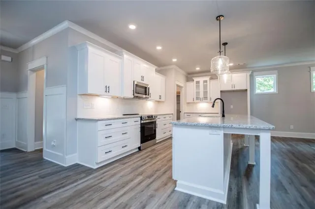 a view of a hallway with wooden floor and stairs