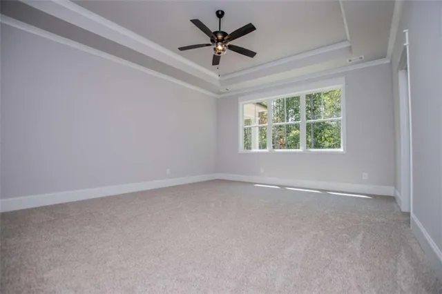 a view of empty room with fireplace and fan