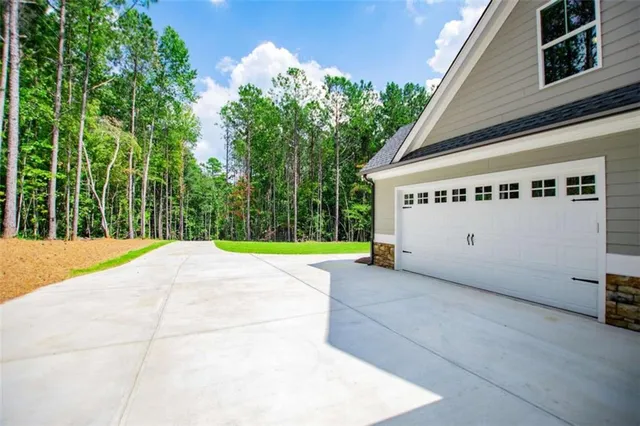a kitchen with wooden floors and white cabinets
