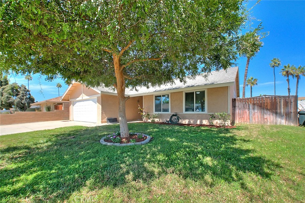 9539 Hermitage Lane Riverside, CA 92503 - Photo 1 of 1 a backyard of a house with table and chairs plants and large tree