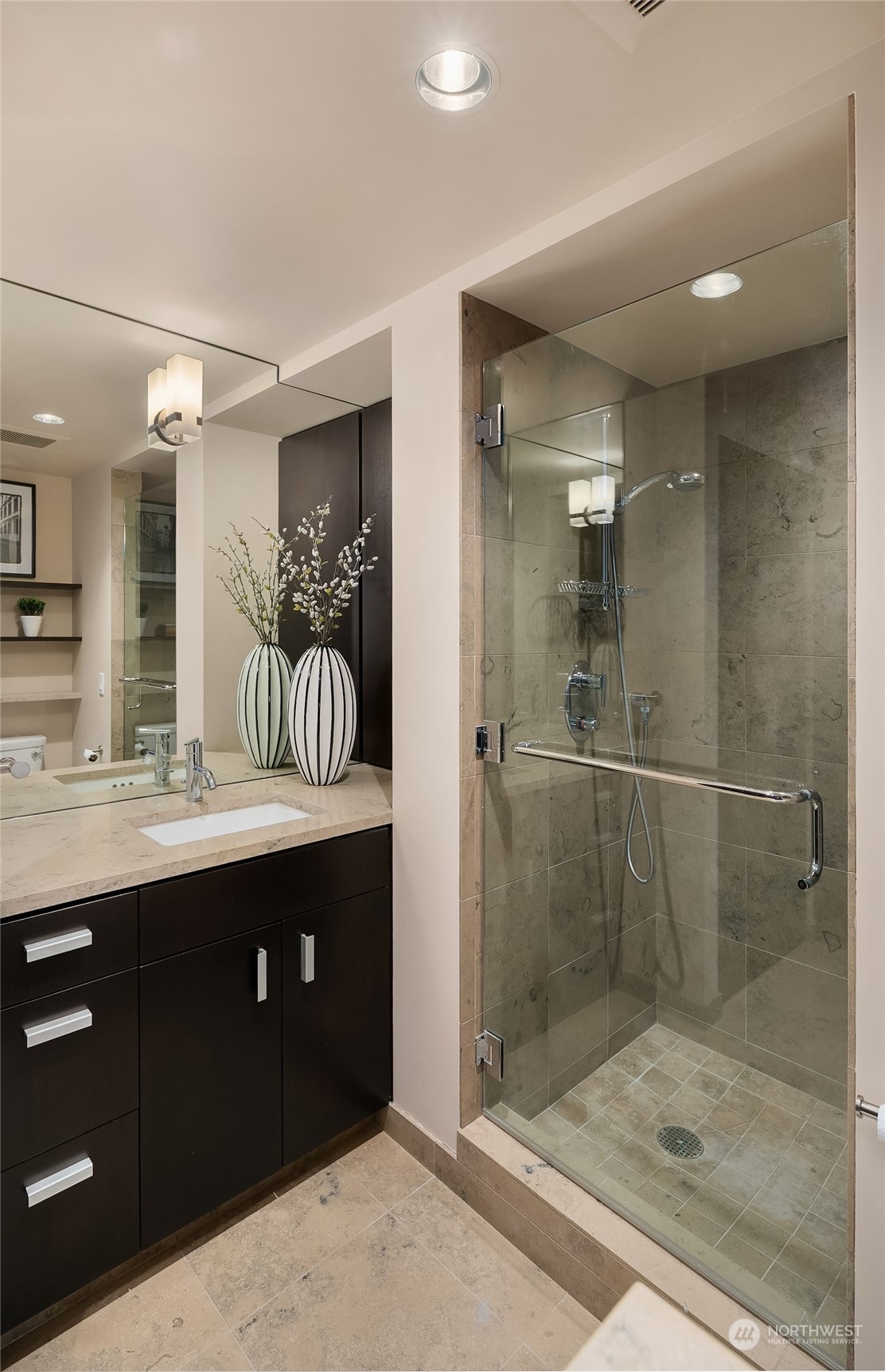 1301 Spring Street, Unit 29H Seattle, WA 98104 - Photo 19 of 29 a bathroom with a shower sink and mirror