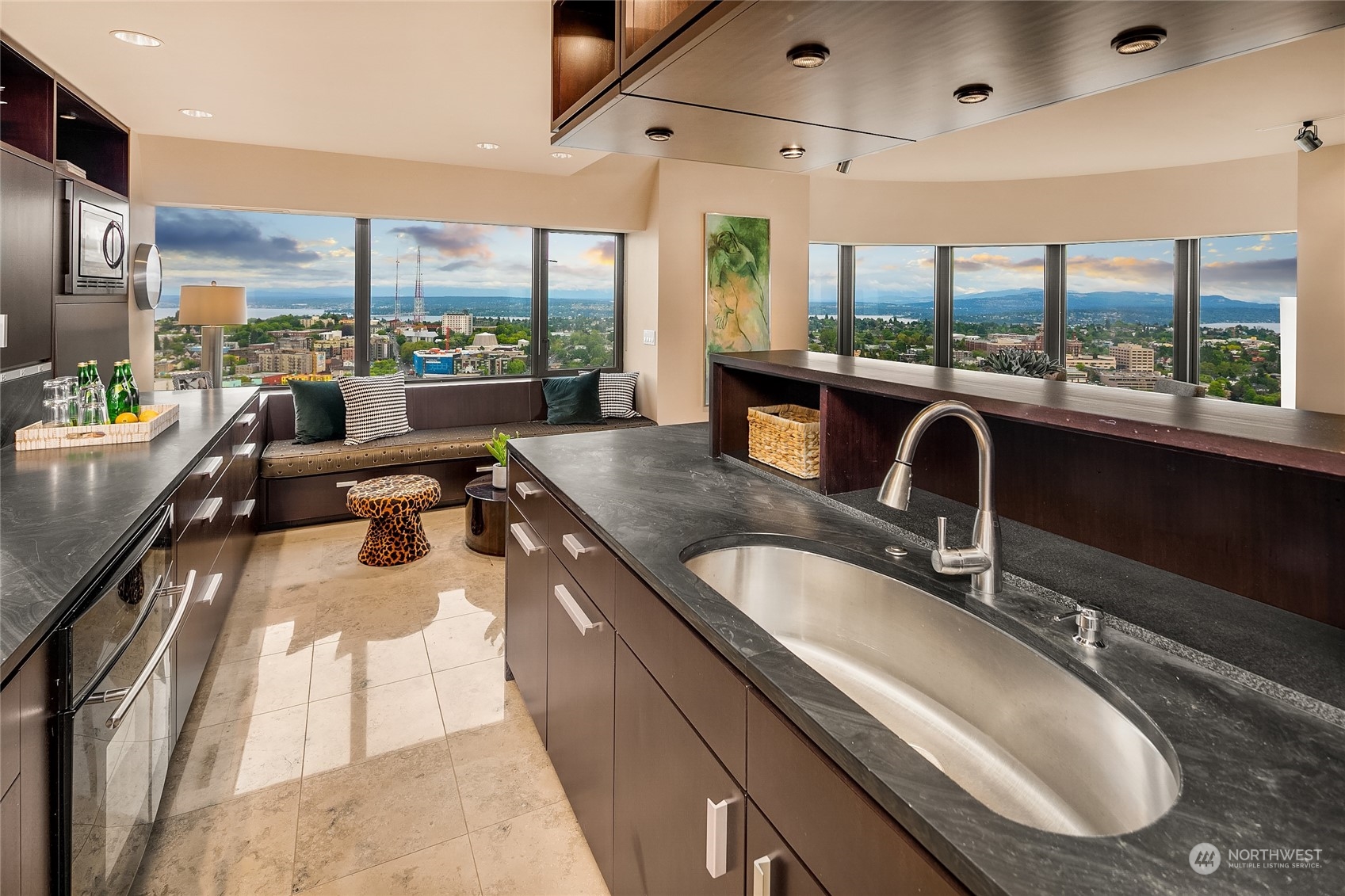 1301 Spring Street, Unit 29H Seattle, WA 98104 - Photo 8 of 29 a large kitchen with kitchen island granite countertop a large window