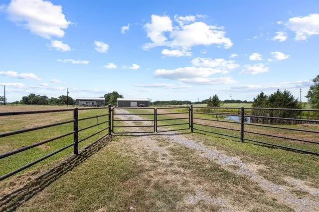 a view of a yard with wooden fence