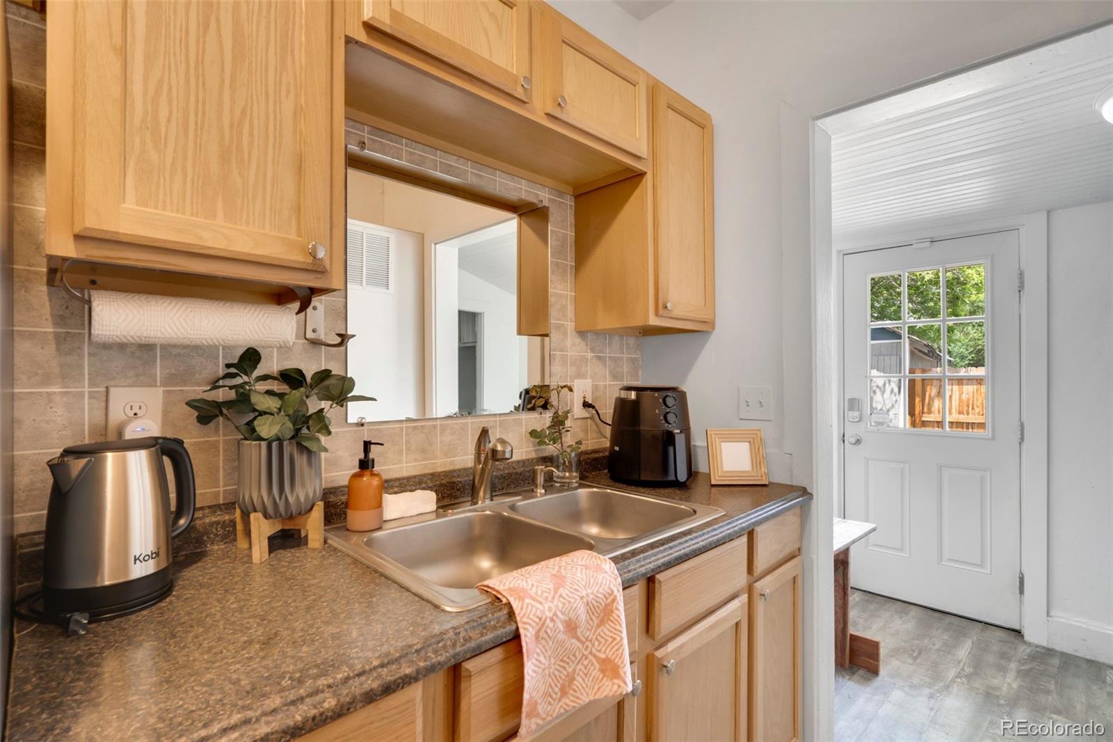 26 Main Street Windsor, CO 80550 - Photo 11 of 14 a kitchen with stainless steel appliances granite countertop a sink a stove and a refrigerator
