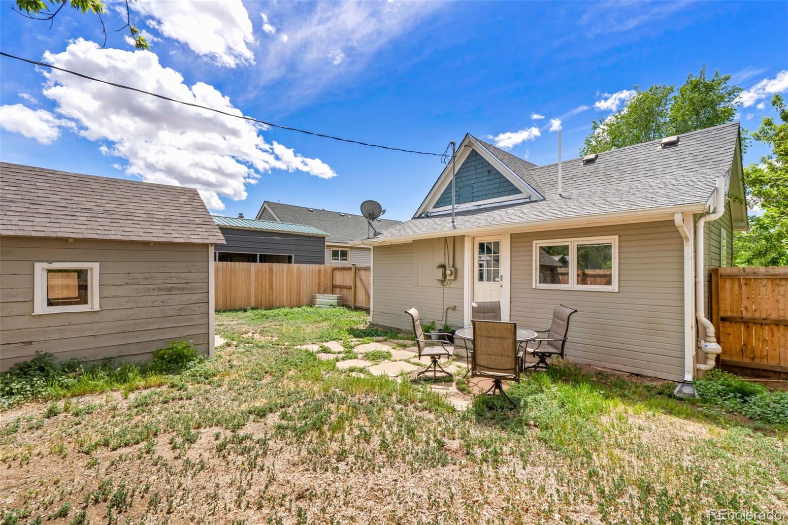 26 Main Street Windsor, CO 80550 - Photo 13 of 14 a backyard of a house with seating space