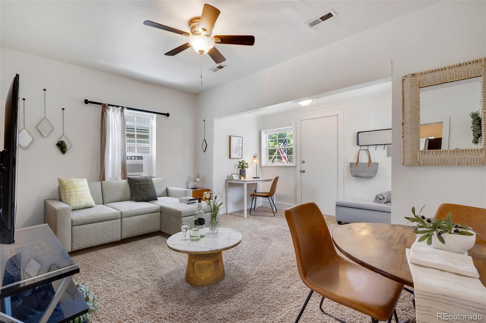 26 Main Street Windsor, CO 80550 - Photo 2 of 14 a living room with furniture and a large window