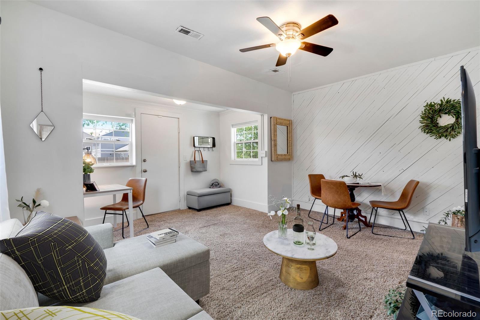 26 Main Street Windsor, CO 80550 - Photo 3 of 14 a living room with furniture and a chandelier