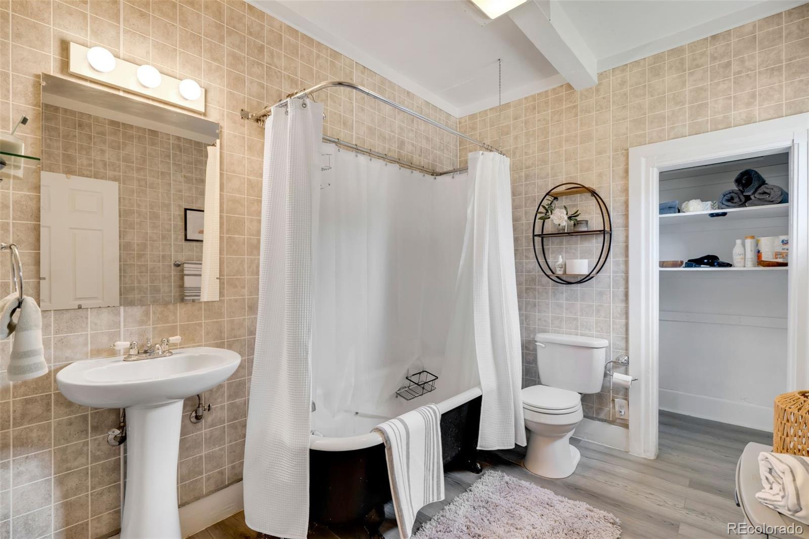 26 Main Street Windsor, CO 80550 - Photo 7 of 14 a bathroom with a sink toilet and a mirror