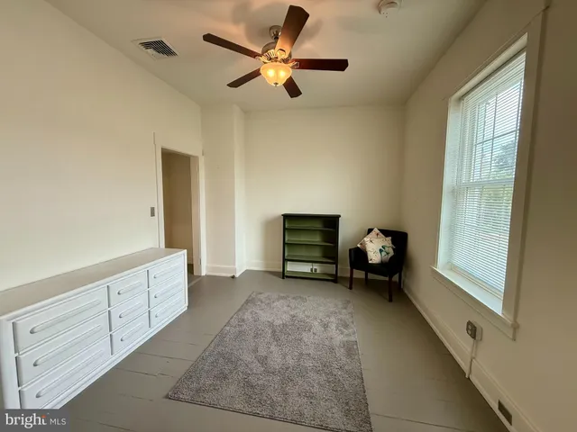 a view of room with furniture and windows