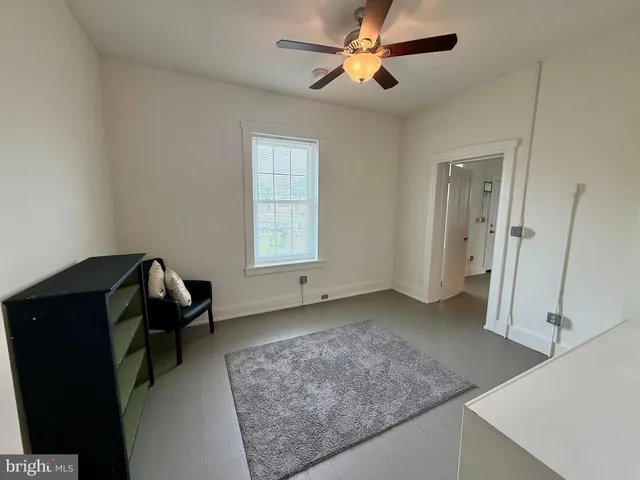 a view of a livingroom with furniture and a window