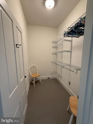 a view of storage and utility room with racks on the wall