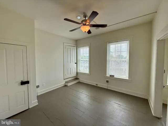 a view of a livingroom with a ceiling fan and window
