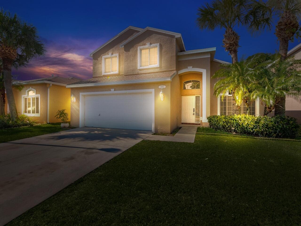 2450 Southeast Springtree Place Stuart, FL 34997 - Photo 21 of 23 a front view of a house with a garden