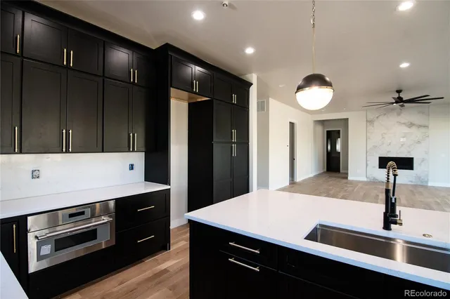 a kitchen with a sink and stainless steel appliances