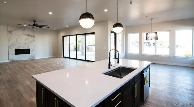 a kitchen with a stove a sink and a refrigerator