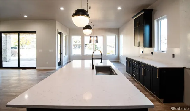 a large white kitchen with a large window