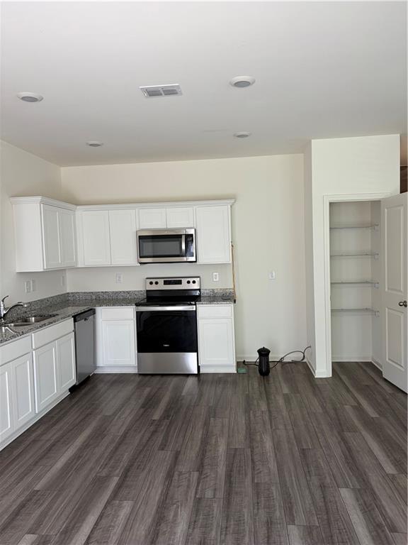 3512 Condor Court Atlanta, GA 30331 - Photo 19 of 19 a kitchen with wooden floors and appliances