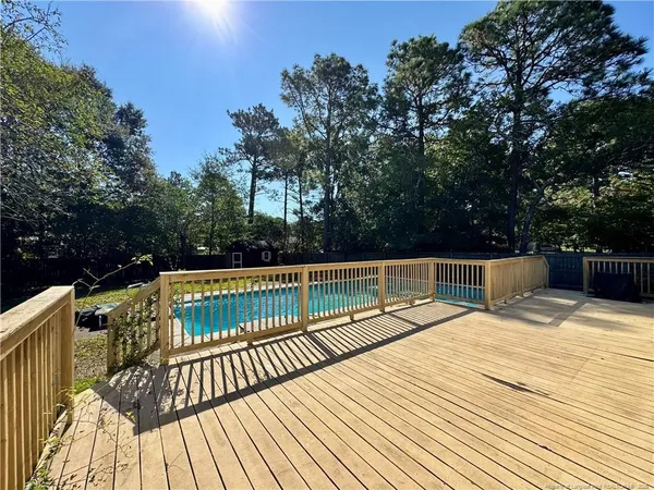 a view of balcony with wooden floor and outdoor seating