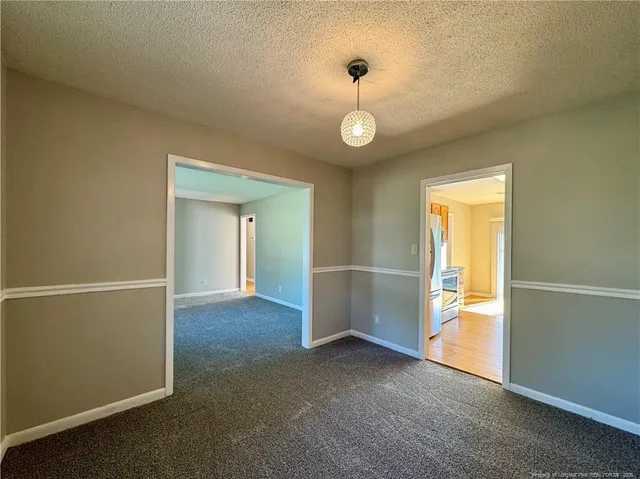 an empty room with windows and entrance