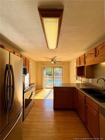 a kitchen with stainless steel appliances granite countertop a sink and a refrigerator