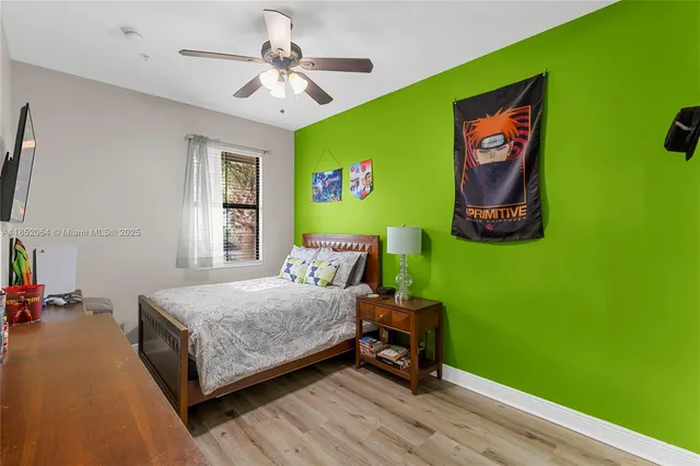 a bedroom with bed and a large window