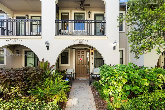 a front view of a house with outdoor seating