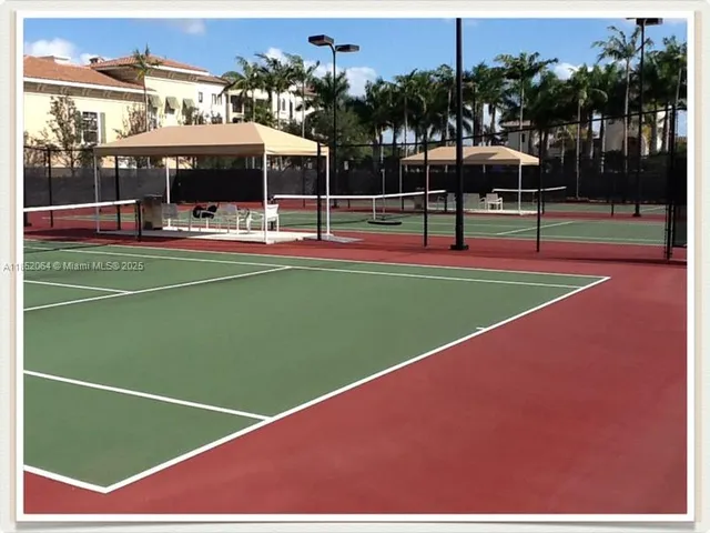 a view of backyard of house with palm trees