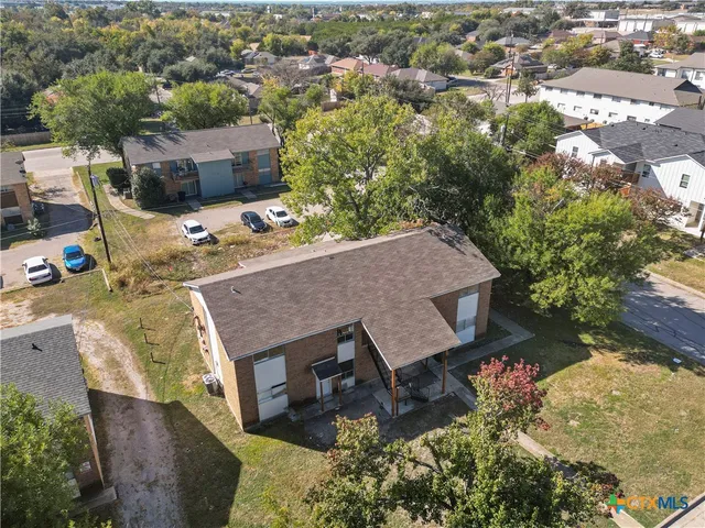 an aerial view of a house with a yard basket ball court and outdoor seating