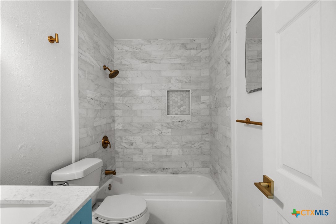 2213 Valley Forge Avenue Temple, TX 76504 - Photo 14 of 18 a bathroom with a sink toilet and bathtub