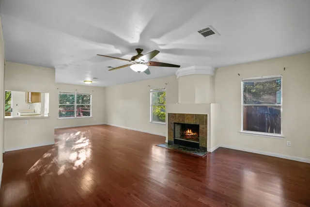 a view of a livingroom with window fireplace and wooden floor