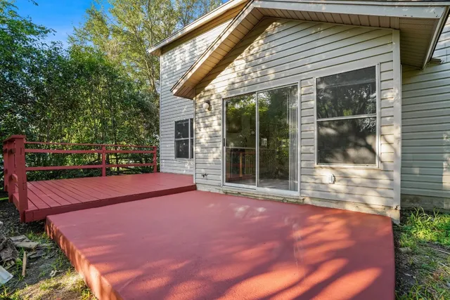 a view of a backyard with a large window and brick wall