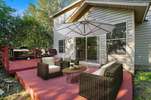 a patio with couches table and chairs and potted plants