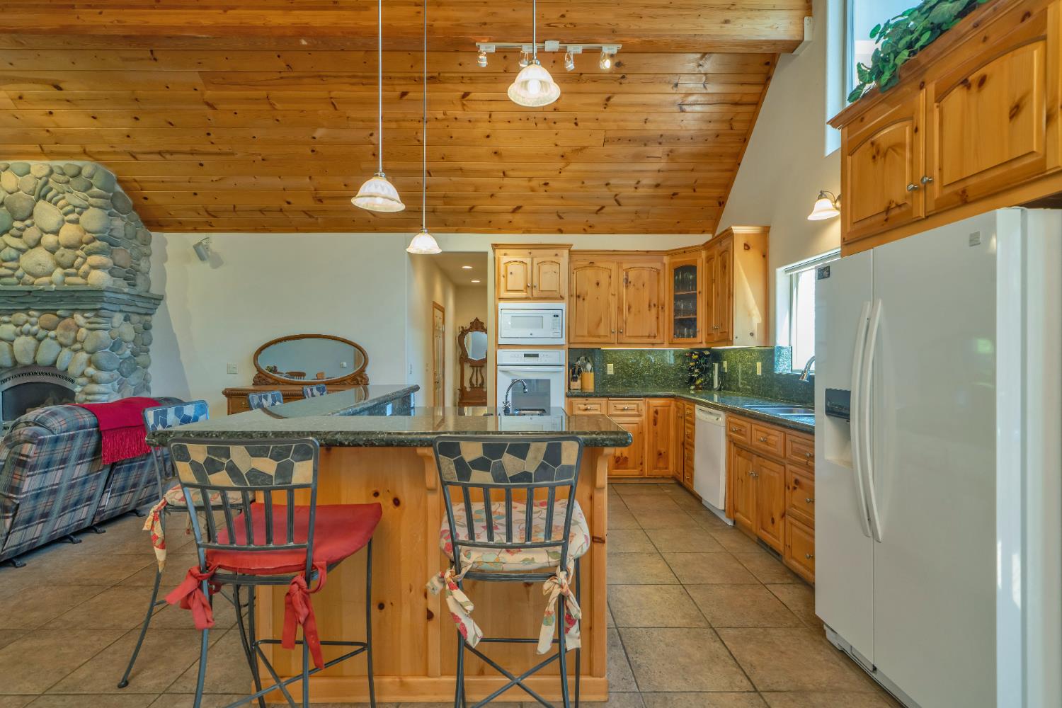 4117 Pearl Road Pollock Pines, CA 95726 - Photo 16 of 47 a kitchen with stainless steel appliances kitchen island granite countertop a refrigerator and a stove