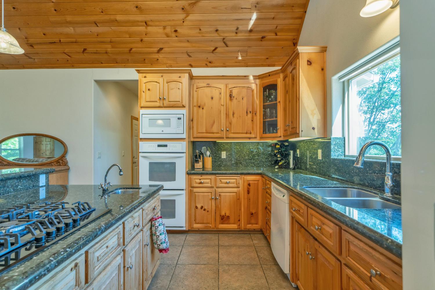 4117 Pearl Road Pollock Pines, CA 95726 - Photo 18 of 47 a kitchen with stainless steel appliances granite countertop a sink and wooden cabinets