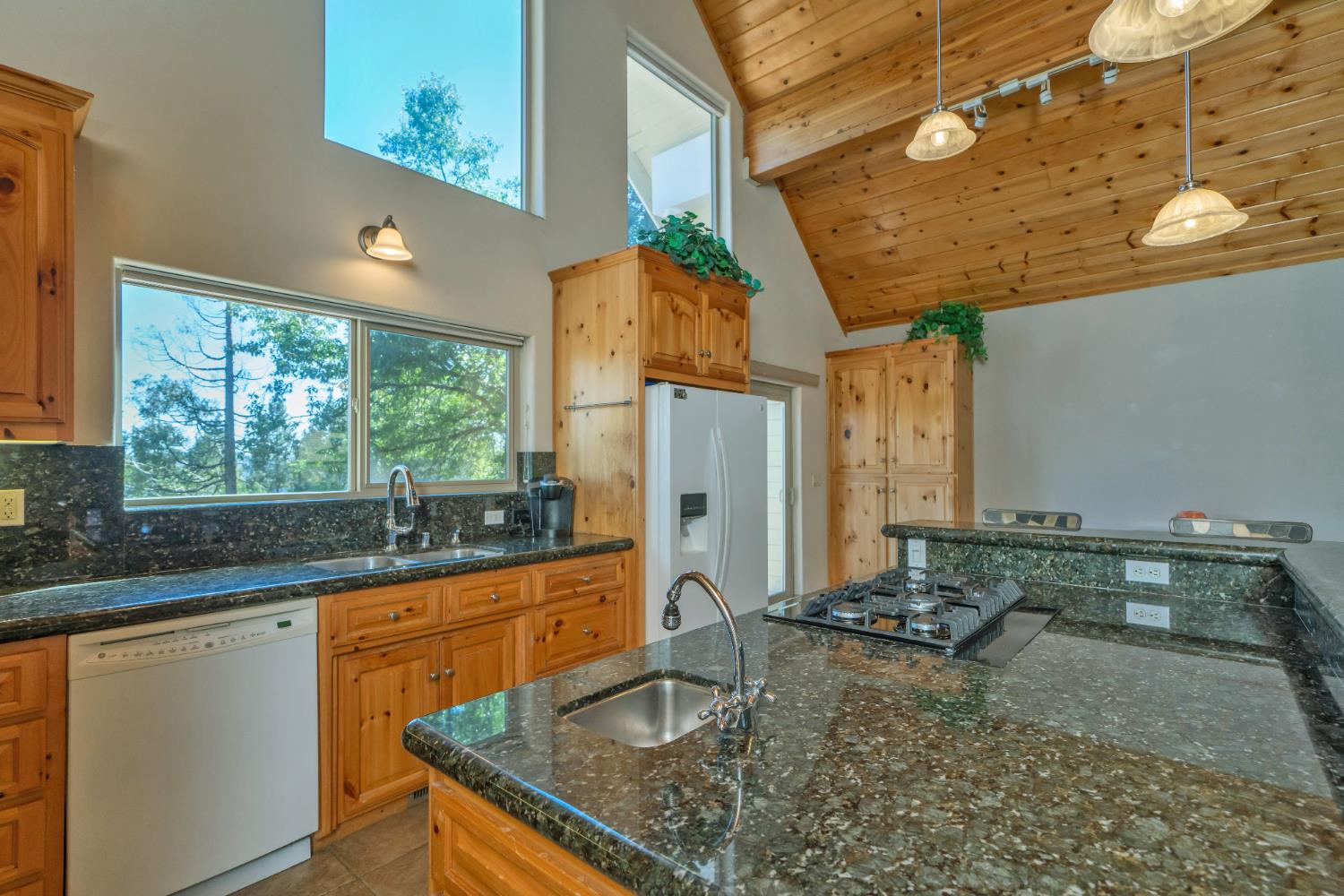 4117 Pearl Road Pollock Pines, CA 95726 - Photo 19 of 47 a kitchen with kitchen island granite countertop a sink a counter top space and cabinets