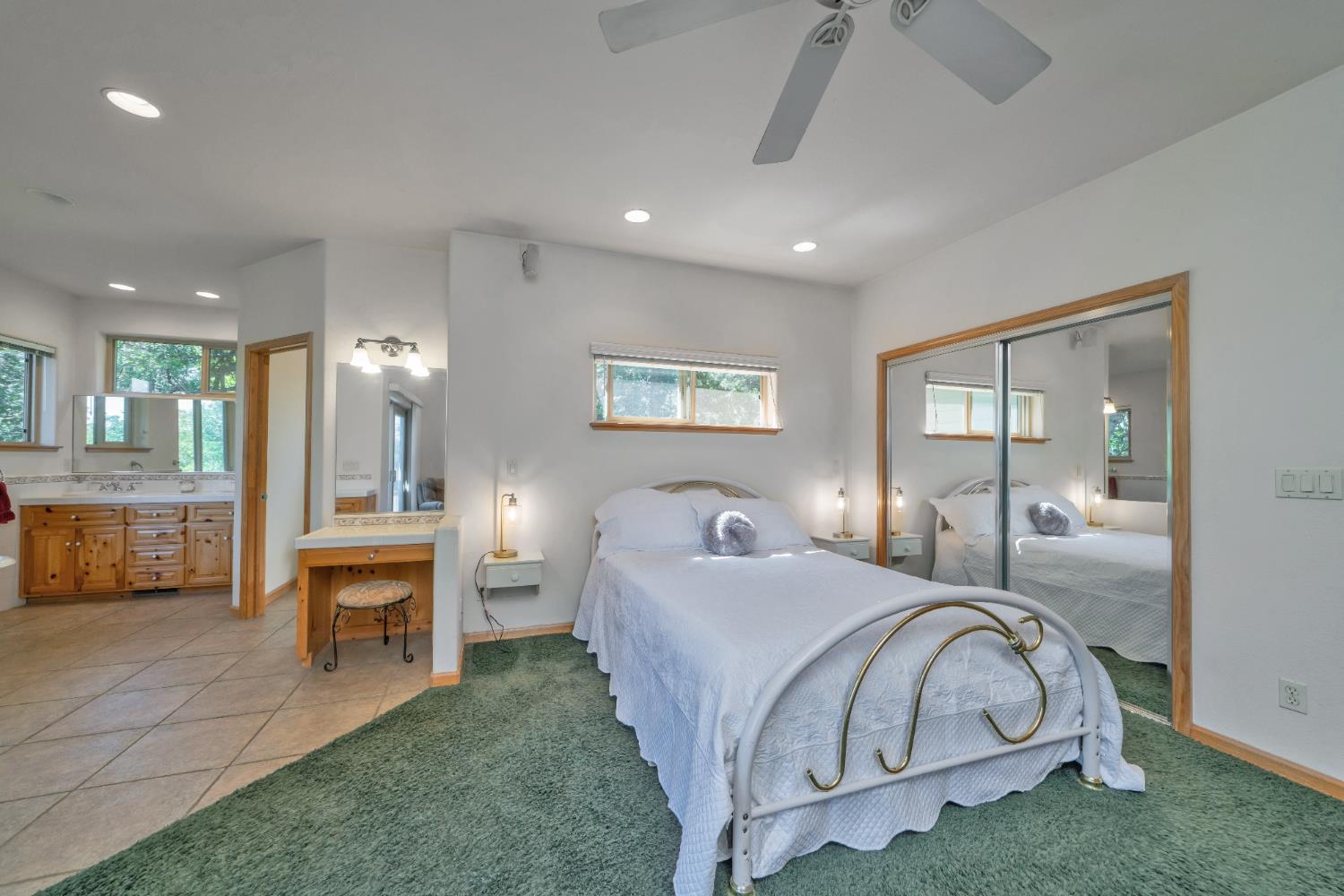 4117 Pearl Road Pollock Pines, CA 95726 - Photo 25 of 47 a spacious bedroom with a large bed and a chandelier