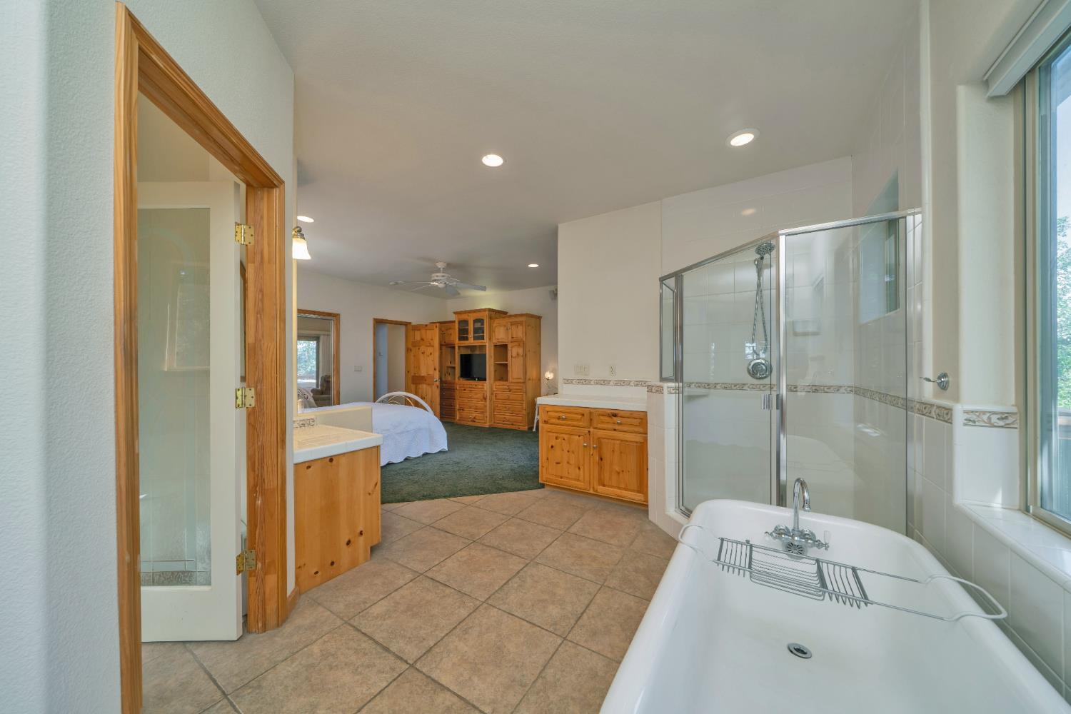 4117 Pearl Road Pollock Pines, CA 95726 - Photo 30 of 47 a bathroom with a tub sink shower and mirror