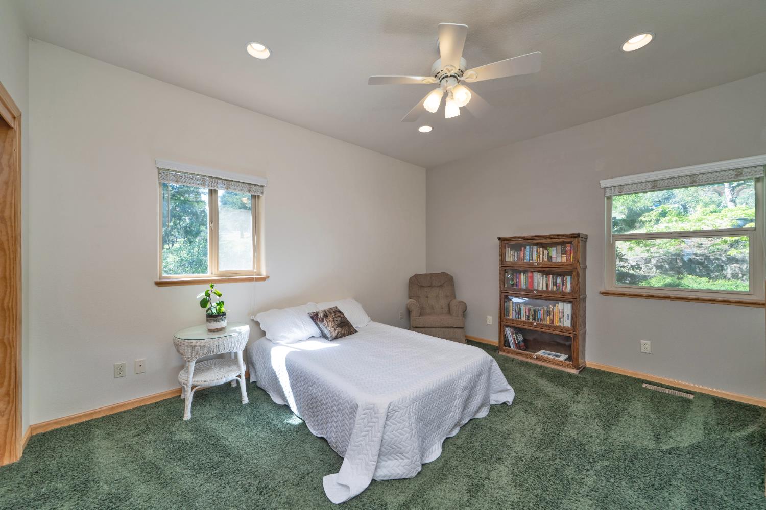 4117 Pearl Road Pollock Pines, CA 95726 - Photo 34 of 47 a spacious bedroom with a bed and a chandelier