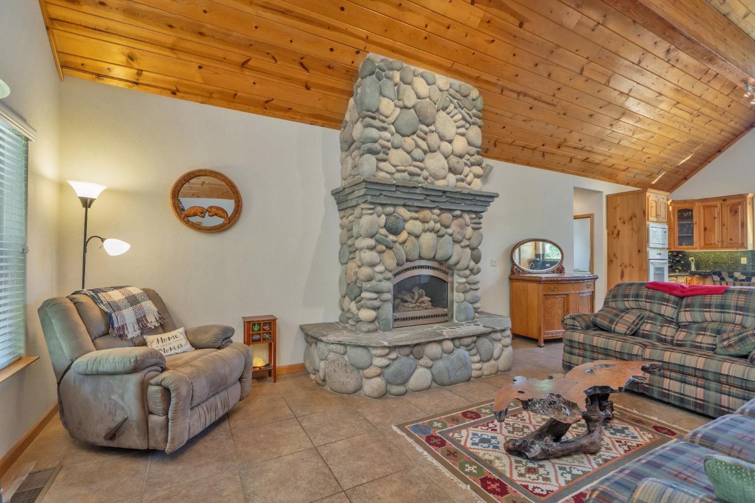 4117 Pearl Road Pollock Pines, CA 95726 - Photo 10 of 47 a living room with furniture and a fireplace