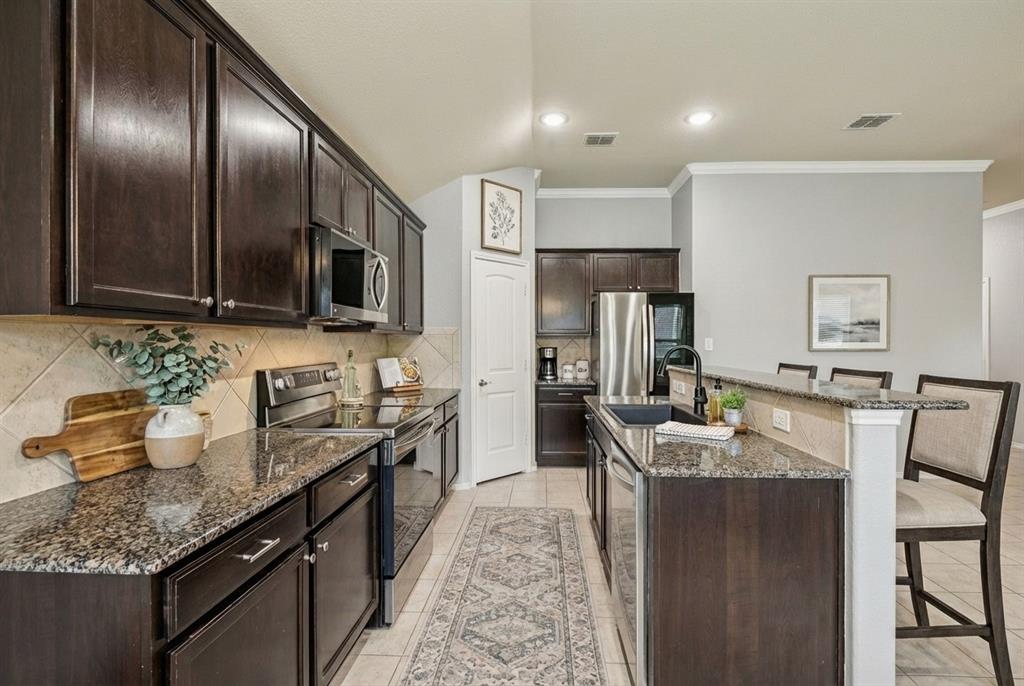 513 Wichita Trail McKinney, TX 75071 - Photo 4 of 15 Breakfast bar option as well. Well appointed kitchen for meal prep!