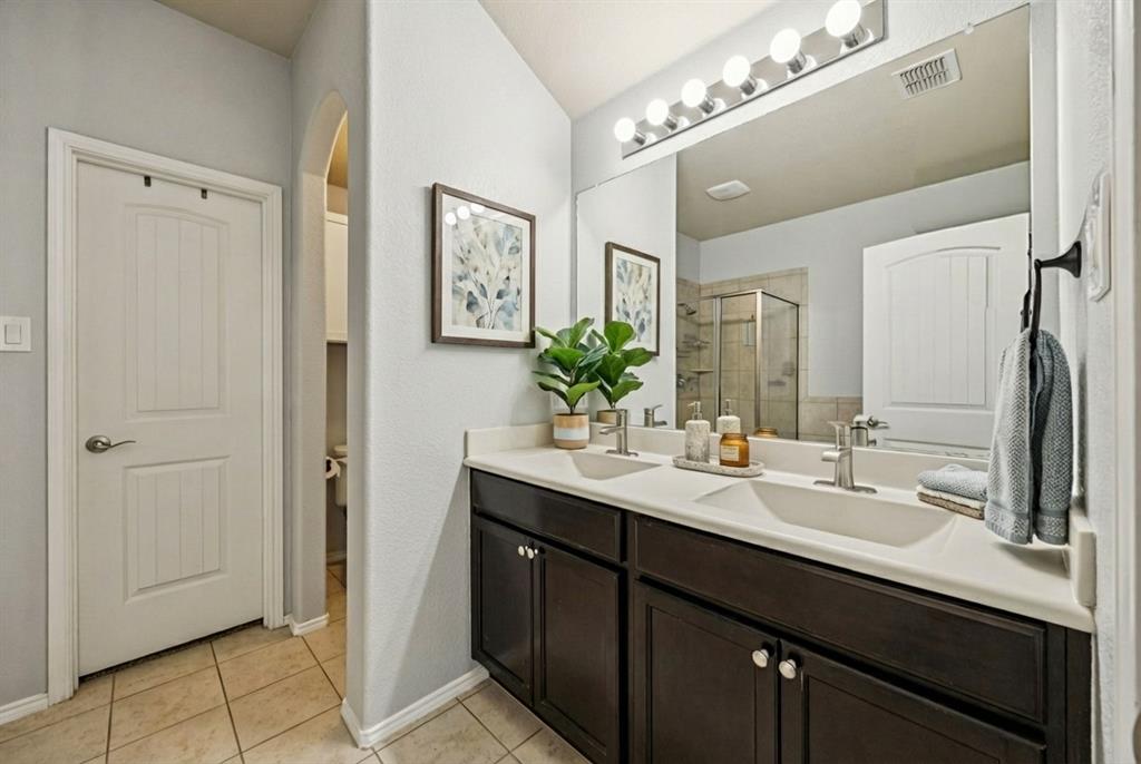 513 Wichita Trail McKinney, TX 75071 - Photo 6 of 15 a bathroom with a double vanity sink and a mirror
