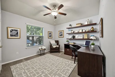 a backyard of a house with table and chairs