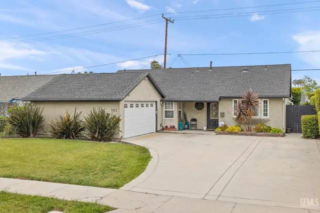a view of a house next to a yard with plants